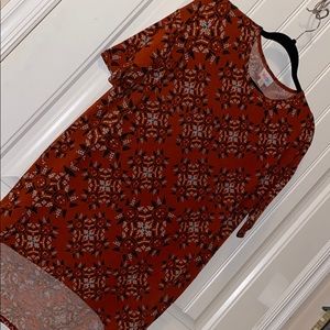 LulaRoe Irma top. Rust background.